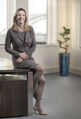 Fotograaf zakelijk portret voor bedrijfsblad redactioneel zittend op een bureau gefotografeerd op locatie door fotograaf. www.marijnissenfotografie.nl